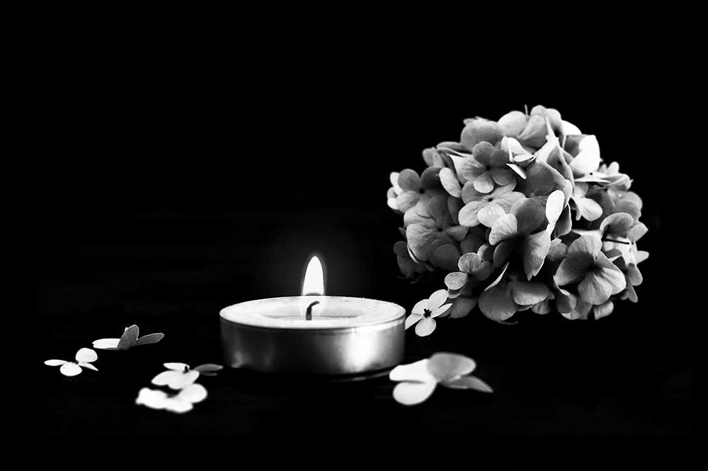 black flower and candle