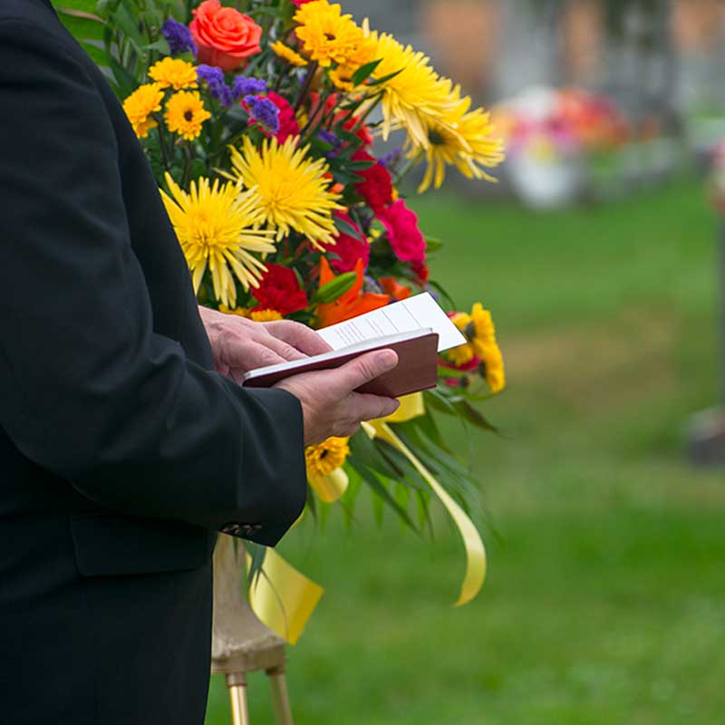 a man holding funeral card